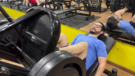 latin man with long hair and beard performing leg press 45 exercise
