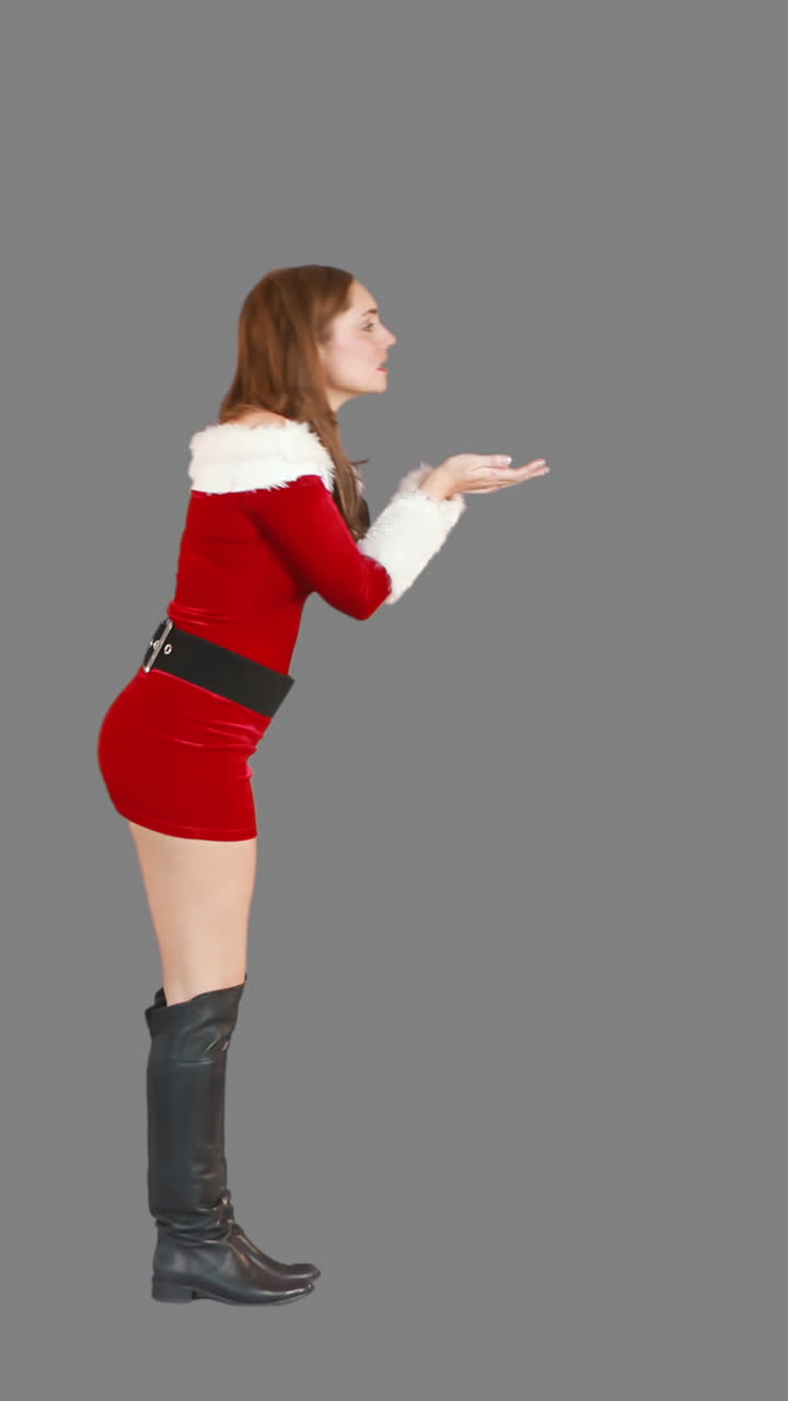 크리스마스 소녀가 고 키스를 불어넣습니다.