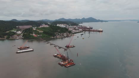 Aerial-view-of-cranes-on-floating-platforms-of-port-São-Francisco-do-Sul,-Babitonga-Bay,-Santa-Catarina,-Brazil