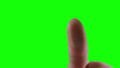 caucasian man pointing on green background