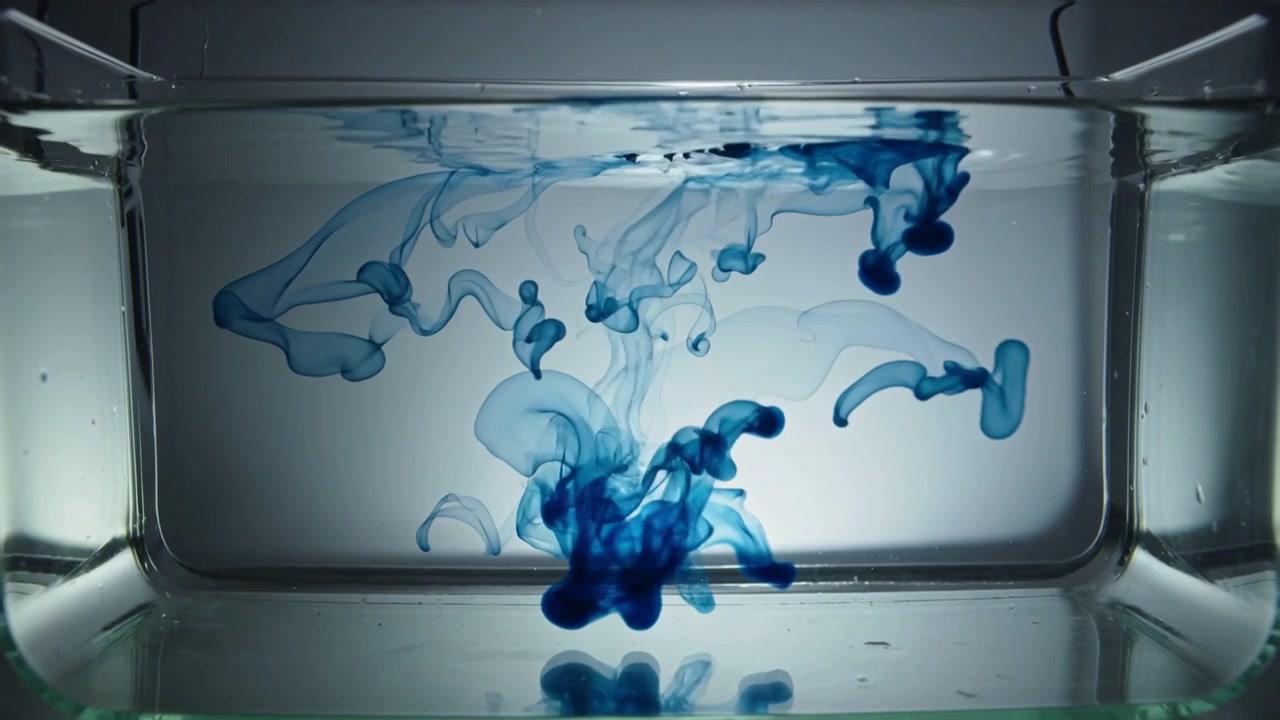 Dropping dye from above, dense blue plume sinking, branching into ribbons in glass tank, backlit