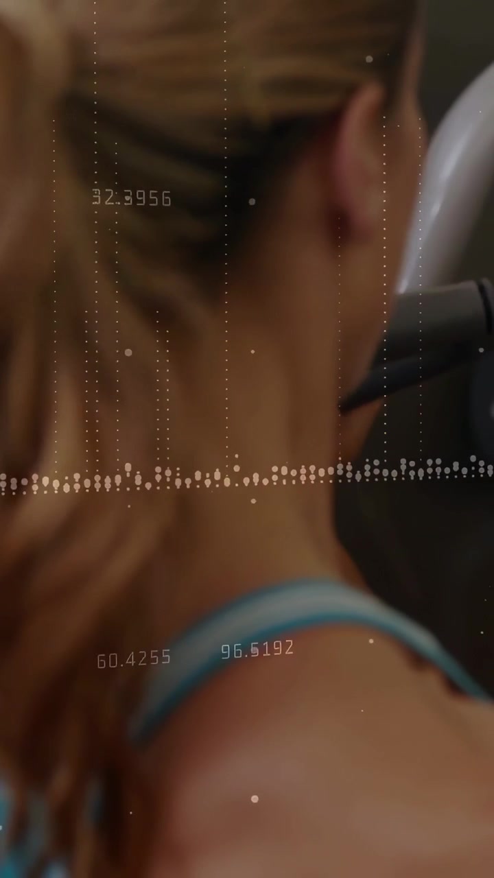 Vertical video: Woman rotating head and raising hand during workout, data overlay tracking posture