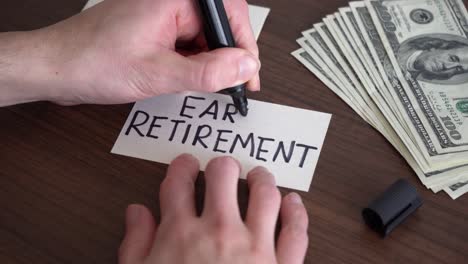 writing the word "early retirement" on a piece of paper