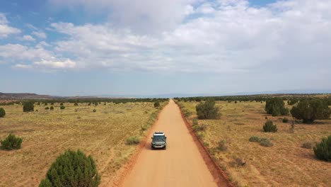 front view of 4x4 car driving on unpaved road in escalante, utah