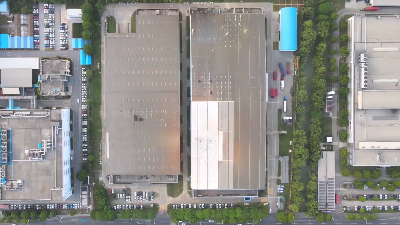 Overhead shot of industrial Big factory warehouse rooftop. Aerial drone shot camera flying forward. Factory rooftop, roof windows, ventilation shafts, flat roof of a big manufacture warehouse.