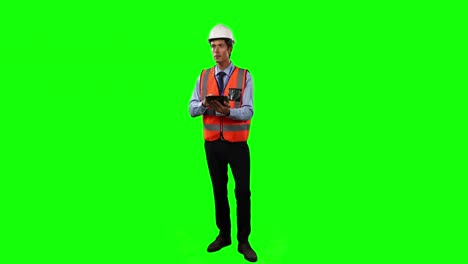 front view of a site foreman using digital tablet with green screen