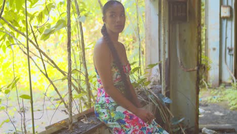 Sexy-young-woman-turns-around-while-sitting-in-the-window-of-an-abandoned-warehouse