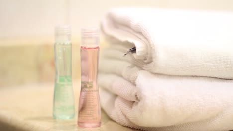 closeup shot of housekeeper placing clean bath towels in the bathroom