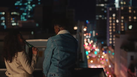 happy multiracial couple chatting enjoying rooftop view of city sharing connection friends drinking alcohol hanging out on weekend date