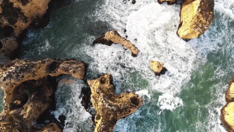 bird's eye view of algarve rocky cliffs and rugged coastline, ponta da piedade, lagos portugal - aerial shot