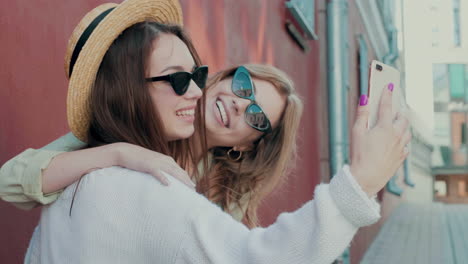 two friends taking a selfie outdoors