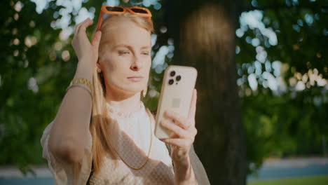 woman using phone in a park