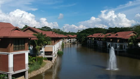 wide-shots-of-homes-by-the-lake-with-bird-flying-and-blue-sky-in-the-background