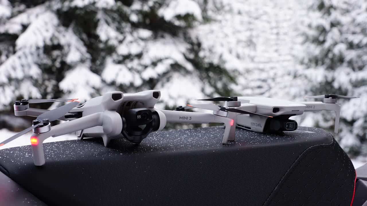 Two Drones Positioned on a Surface in a Snowy Environment