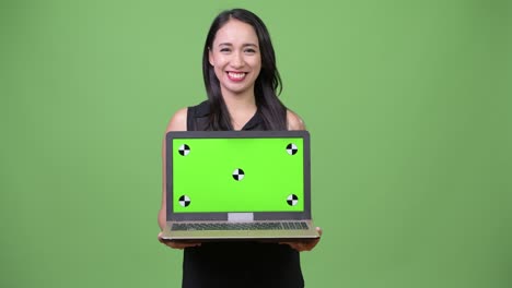Young beautiful Asian businesswoman showing laptop