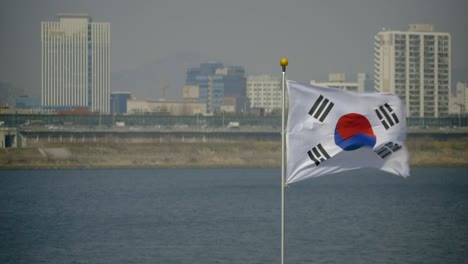 South Korean Flag in Seoul Blowing in Wind Next to Han River