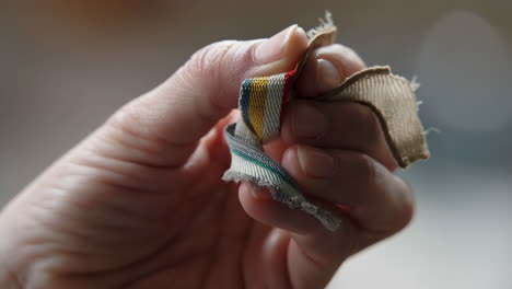 close-up of a hand holding a piece of fabric