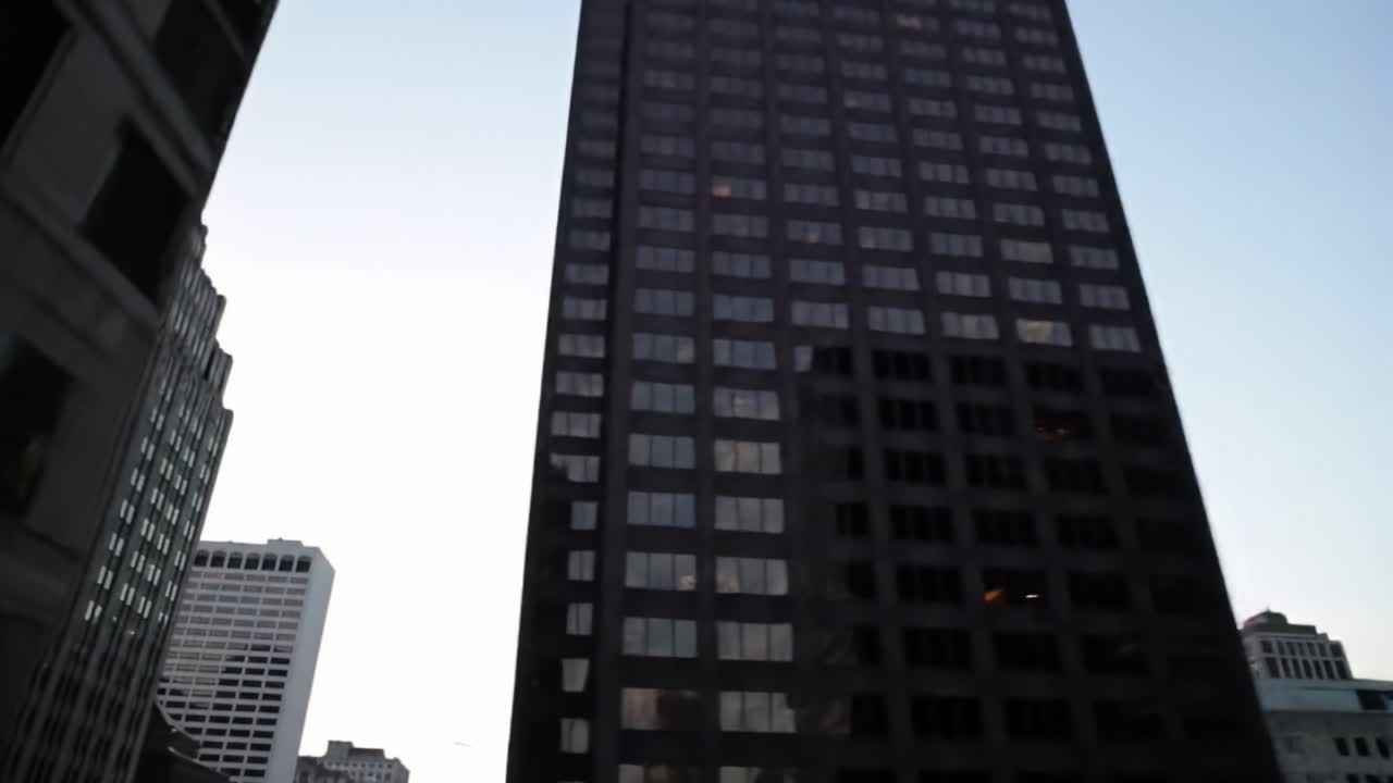 As the sun sets, the city transforms with stunning skyscrapers reflecting the twilight hues. This view captures the essence of urban life in a bustling metropolis.