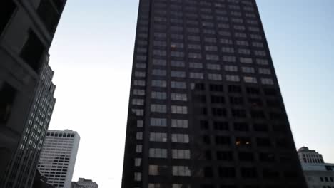 as the sun sets, the city transforms with stunning skyscrapers reflecting the twilight hues. this view captures the essence of urban life in a bustling metropolis.