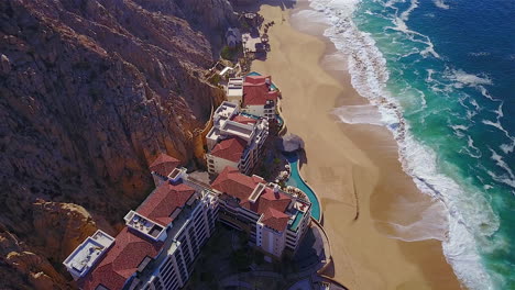 this is 4k drone footage of a resort, on the beach, in cabo san lucas mexico