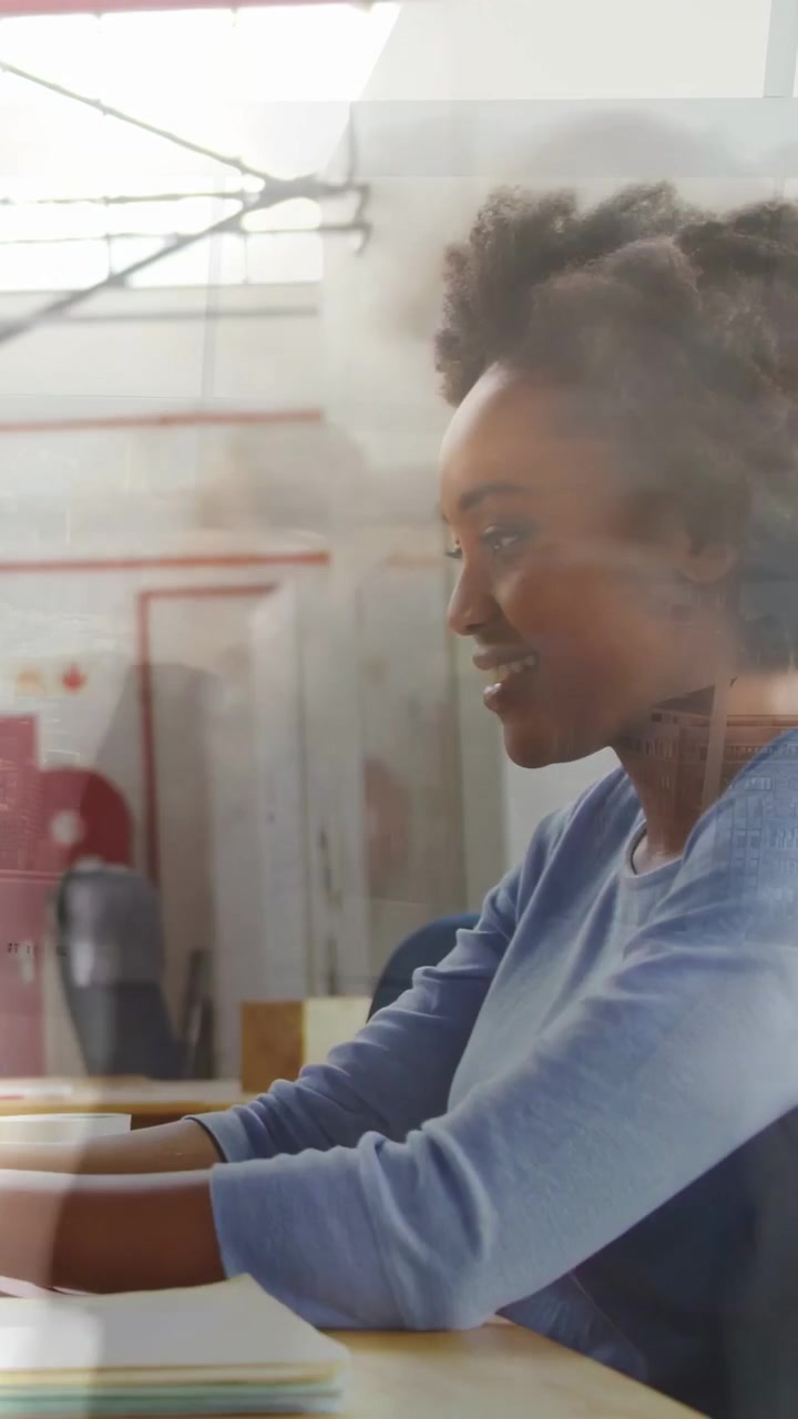 Vertical video: Hands reaching keys, designer typing, checking notes, skyline reflecting over glass