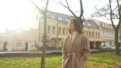 woman in a park in the city on an autumn day