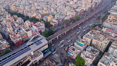 hyderabad metro station with buildings and road at day time, push back, tilt up, drone shot, 4k.