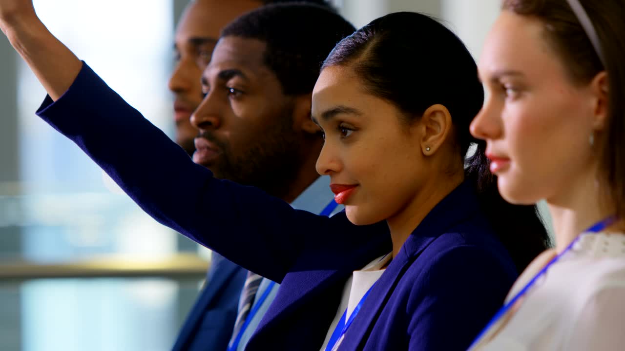 Businesswoman raising hand in the business seminar 4k