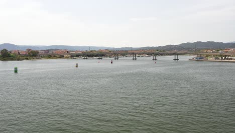 drone-flight-over-the-buoyed-water-to-the-bridge-in-olbia-sardinia