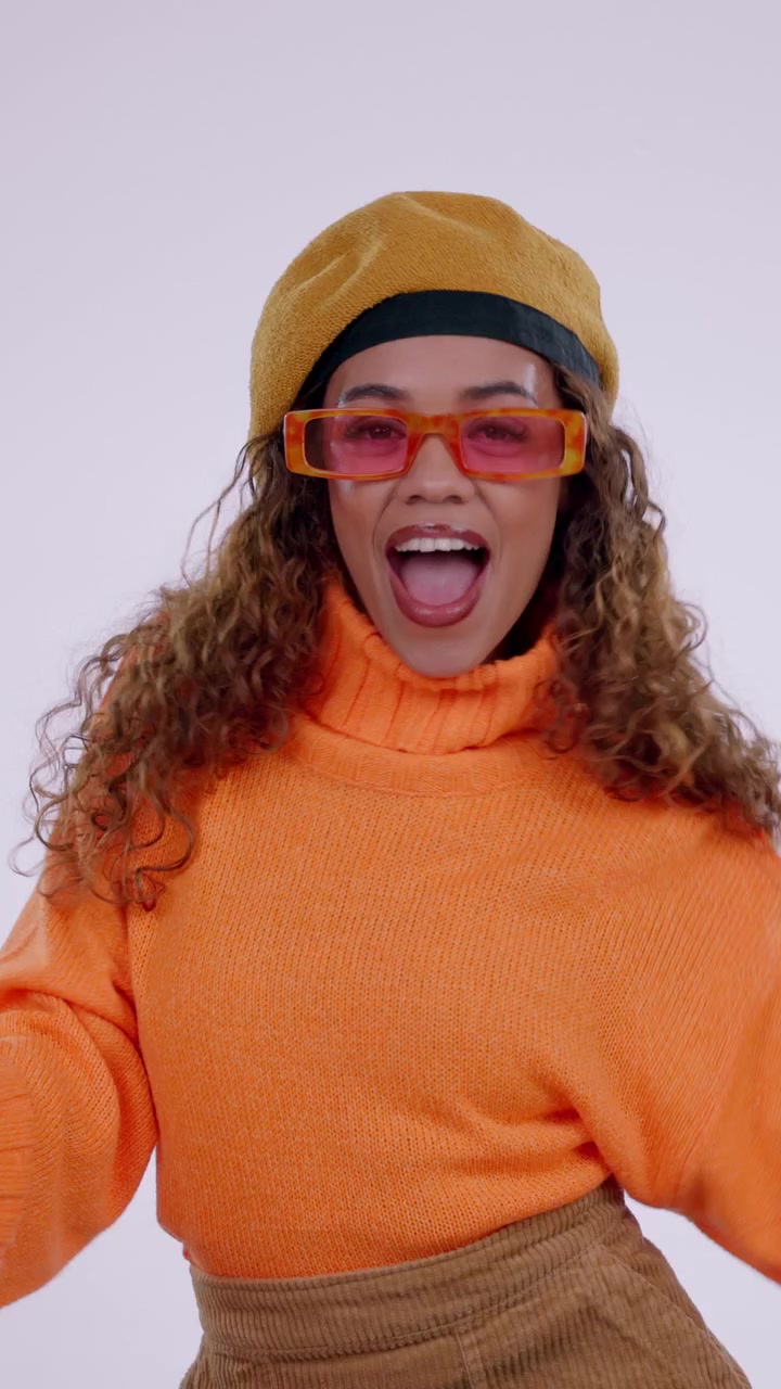 Stylish Young Woman Dancing in Orange Sweater and Beret