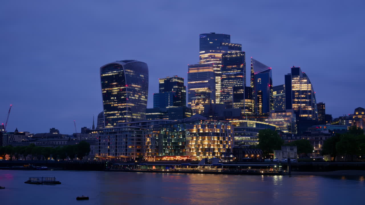 Cityscape view showing the Thames River, modern skyscrapers, including the Walkie Talkie building, and the Tower of London