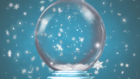 animación de un globo de nieve sobre la nieve que cae sobre un fondo azul
