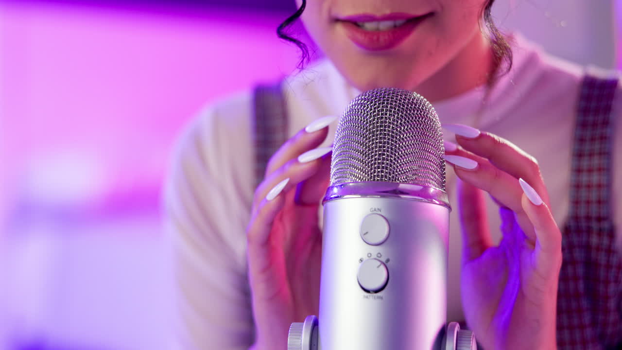 Woman recording ASMR with microphone