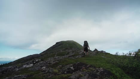 hiker on mountain hike trails in lurøyfjellet, norway