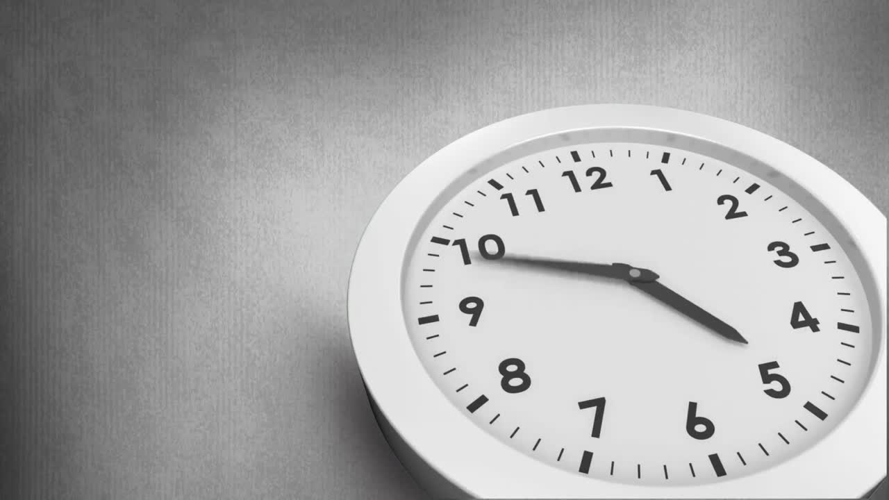 Animation of black and white clock moving fast on grey background