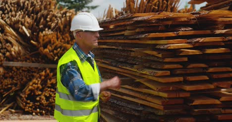 Male-Worker-Examining-Plank'S-Stack-11