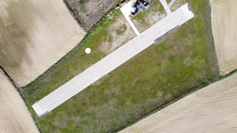 cenital aerial shot of small runway surrounded by grass