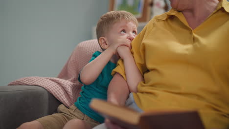 Attentive-grandson-listens-to-granny-reading-fairy-tale-book