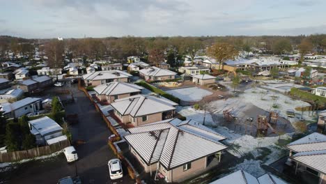 low rise neighborhood in the netherlands, aerial orbit in winter with snow