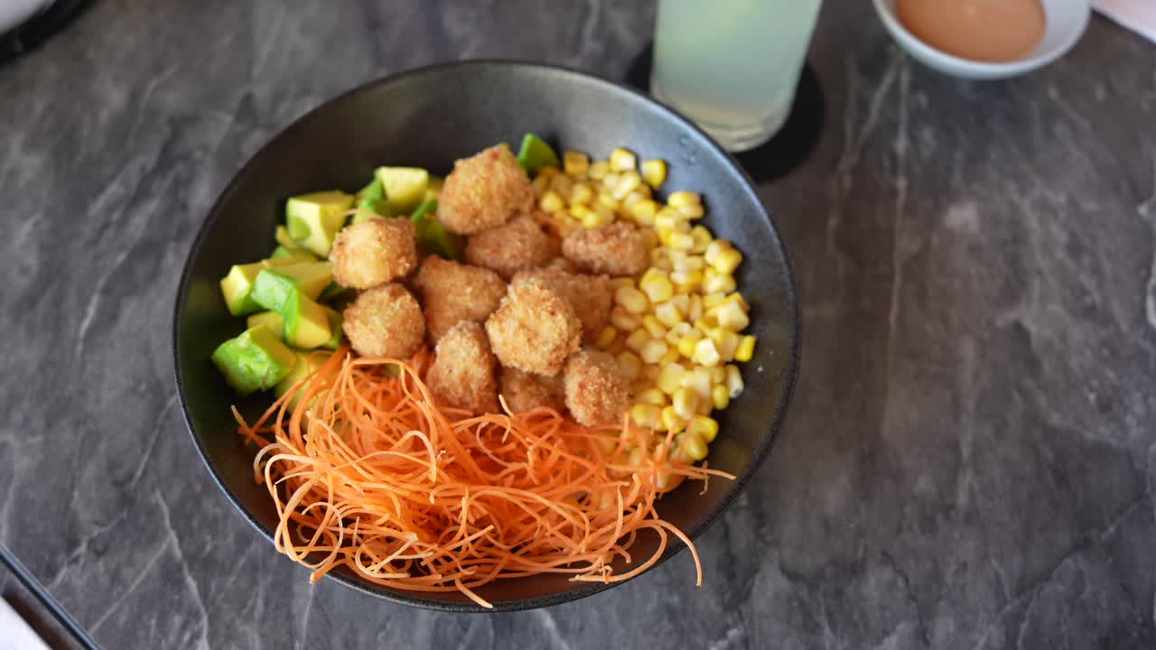 Healthy Food. Fried Chicken Bowl With Avocado, Carrots and Corn. Medium Shot