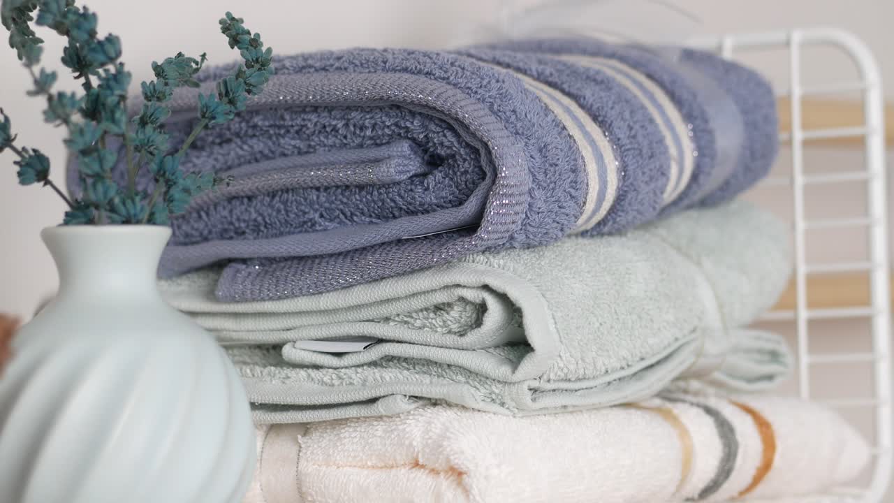 Stacked Towels with Dried Flowers in a Vase