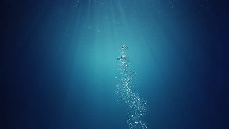 underwater sunlight beams shining from above coming through the deep crystal clear blue water causing a beautiful water lighting reflections curtain with air bubbles rising up to the surface
