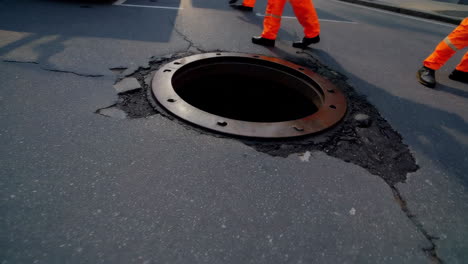 road repair crew working on damaged pavement