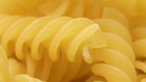 raw uncooked dry italian fusilli pasta. corkscrew spiral shape