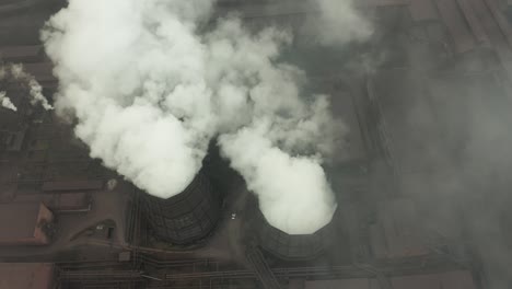 aerial view of an industrial pipe pollutes the air next to people living in the city. create a greenhouse effect