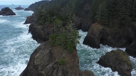 excellent aerial shot of water cresting on coves of the oregon coast