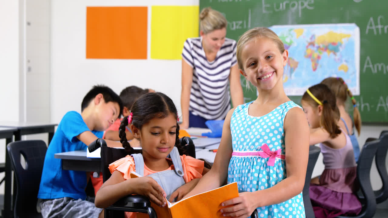 School kids reading book in classroom