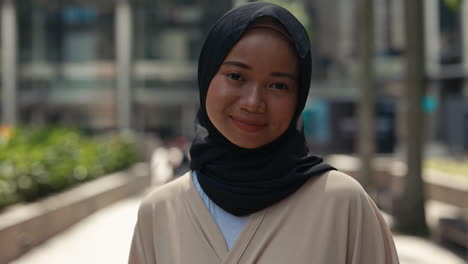 smiling young woman in hijab portrait outdoors