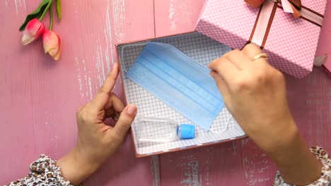 gift box containing face mask and hand sanitizer