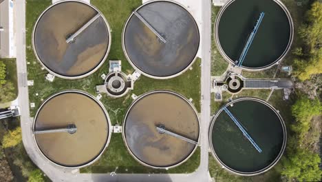 aerial top view of round polls in wastewater treatment plant, filtration of dirty or sewage water. high quality 4k footage